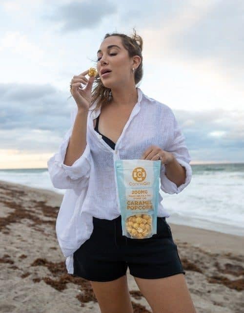 Woman is eating CannaAid Caramel Popcorn 200 mg
